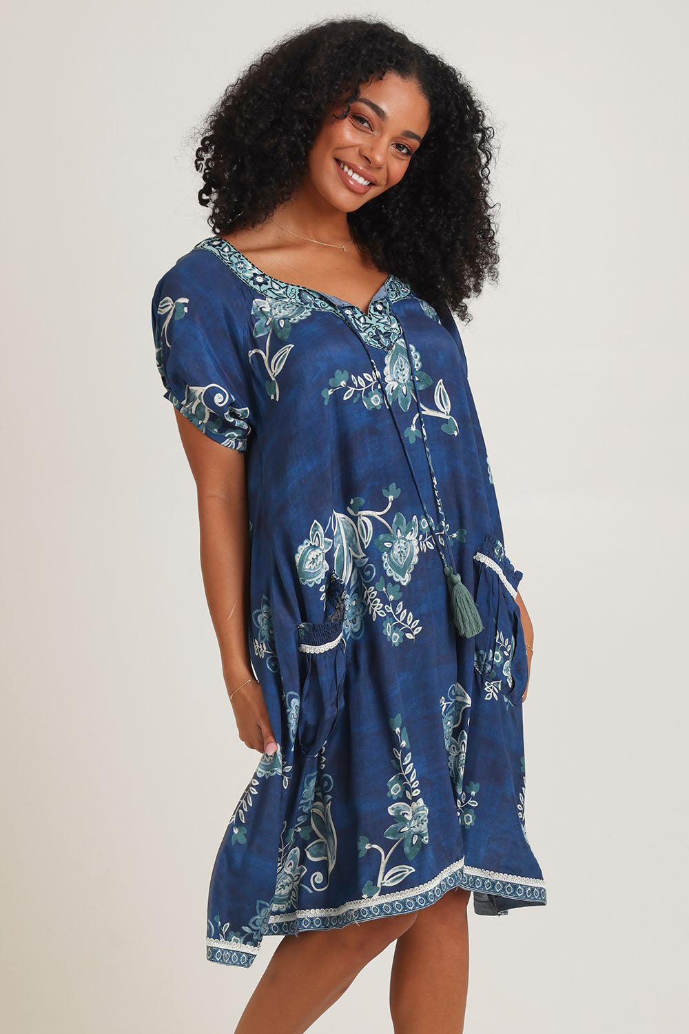 Model Ziara wearing size S of the Sao Paulo Dress in colour Selene (Blue), from the front, cropped image