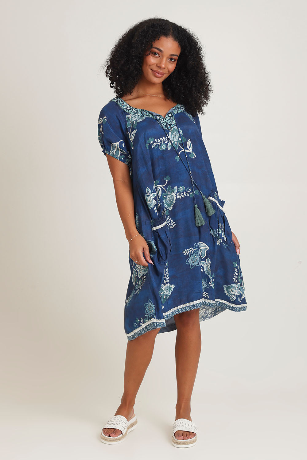 Model Ziara wearing size S of the Sao Paulo Dress in colour Selene (Blue), from the front, showing the whole outfit