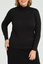 Model Fiona wearing size 16 of the Merino Wool Skivvy in colour Black (Black), from the front, cropped image