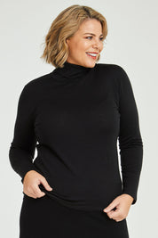 Model Fiona wearing size 16 of the Merino Wool Skivvy in colour Black (Black), from the front, cropped image