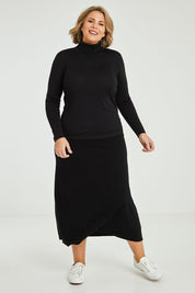Model Fiona wearing size 16 of the Merino Wool Skivvy in colour Black (Black), from the front, showing the whole outfit