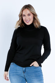 Model Jess wearing size 14 of the Merino Wool Skivvy in colour Black (Black), from the front, cropped image