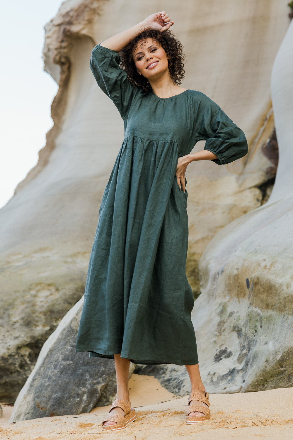 Model Lala wearing size 10 of the Linen Gathered Waist Dress in colour Green (Green), from the front, showing the whole outfit