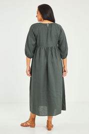 Model Terri-Leigh wearing size 14 of the Linen Gathered Waist Dress in colour Green (Green), from the back
