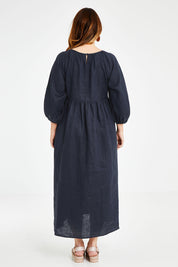 Model Laura wearing size 14 of the Linen Gathered Waist Dress in colour Navy (Blue), from the back