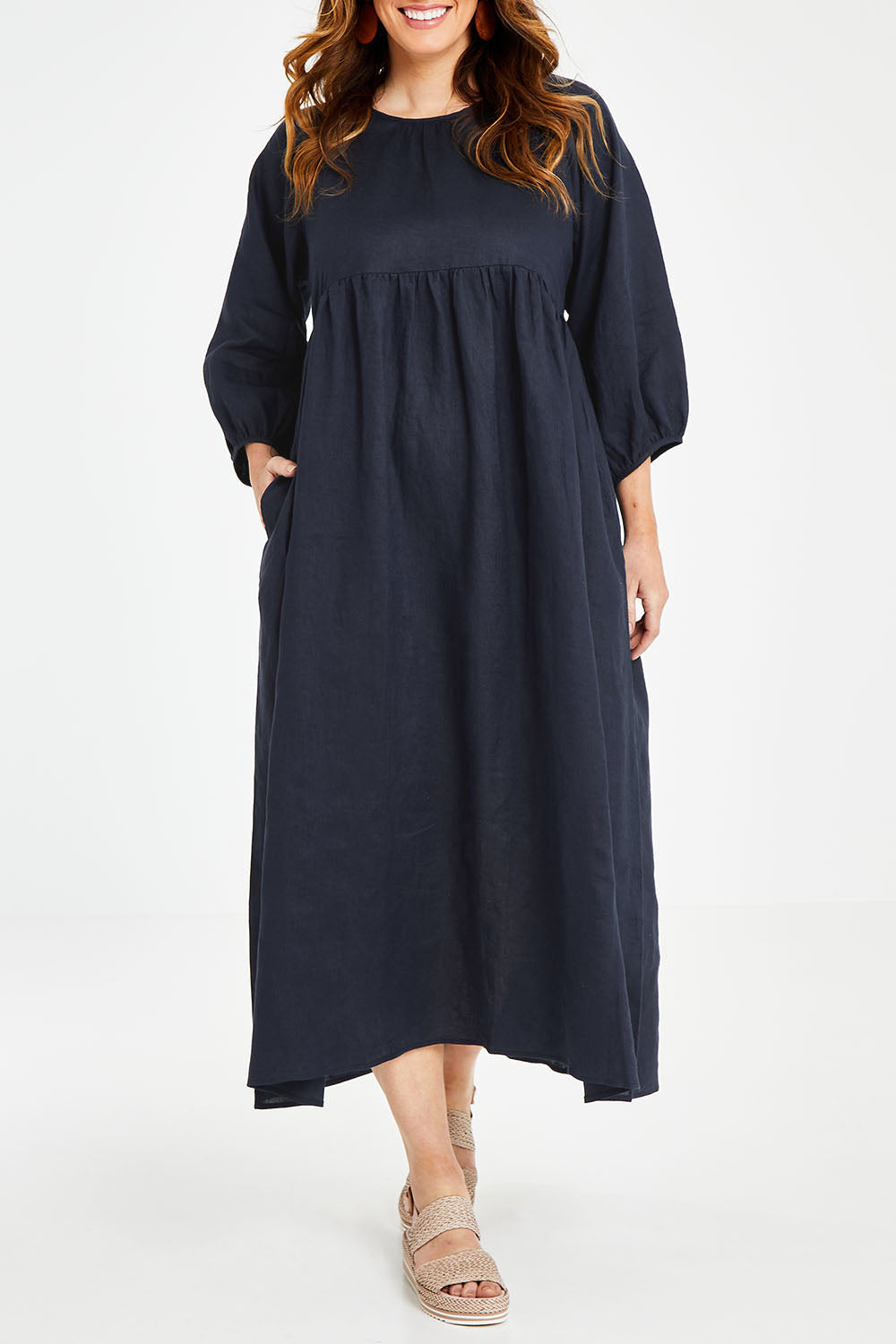 Model Laura wearing size 14 of the Linen Gathered Waist Dress in colour Navy (Blue), from the front, cropped image