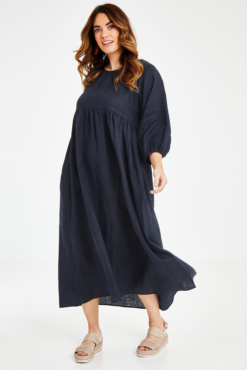 Model Laura wearing size 14 of the Linen Gathered Waist Dress in colour Navy (Blue), from the front, showing the whole outfit
