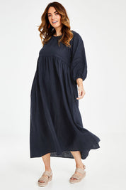 Model Laura wearing size 14 of the Linen Gathered Waist Dress in colour Navy (Blue), from the front, showing the whole outfit