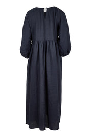 Product shot of the Linen Gathered Waist Dress in colour Navy (Blue), from the back