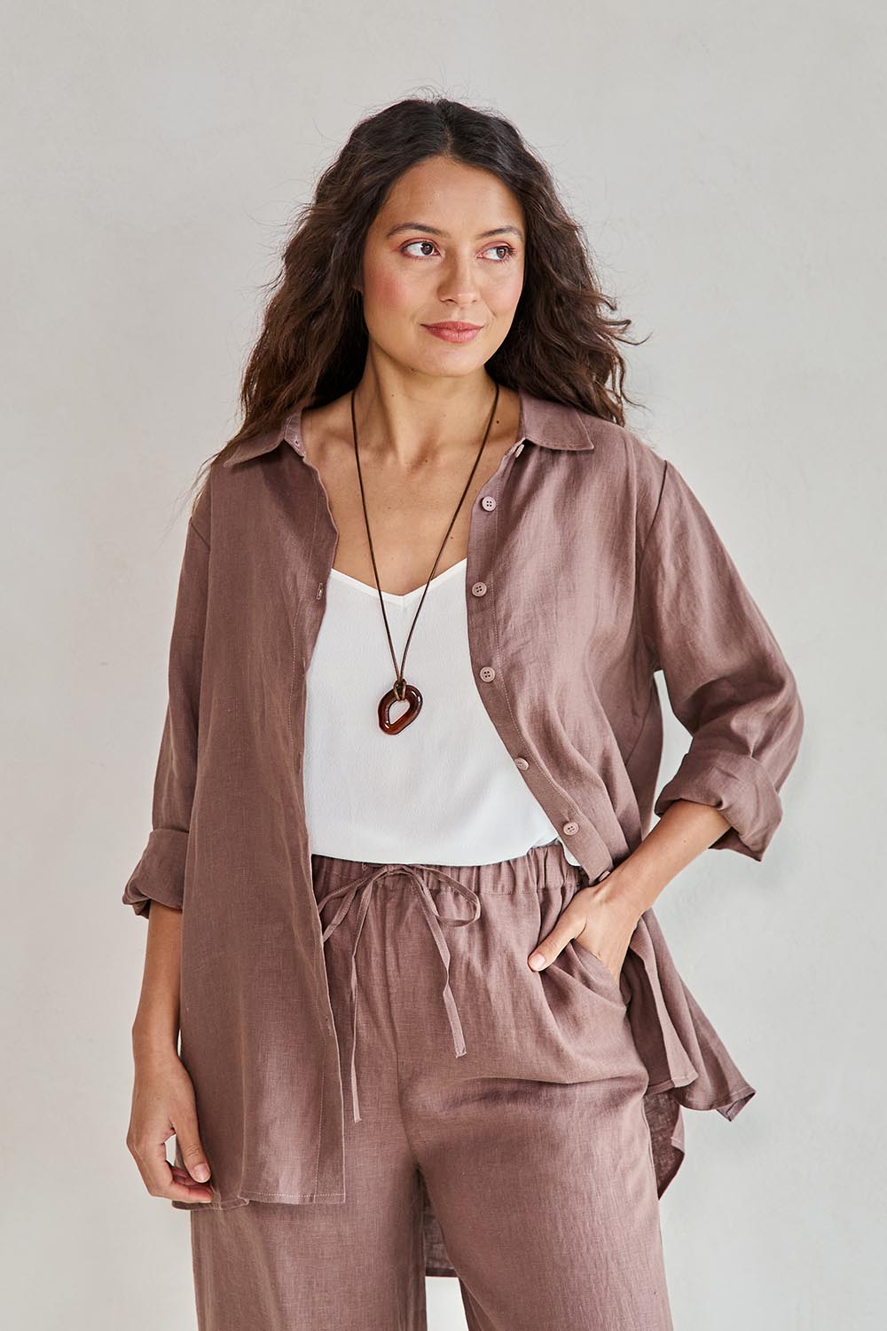 Model Tahneei wearing size 10 of the Linen Oversized Boyfriend Shirt – Coffee in colour Coffee, from an angle
