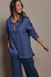 Model Amanda wearing size 10 of the Linen Oversized Boyfriend Shirt in colour Denim (Blue), from the front, cropped image
