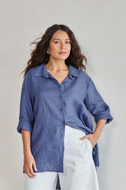 Model Tahneei wearing size 10 of the Linen Oversized Boyfriend Shirt - Denim in colour Denim, in a cropped view