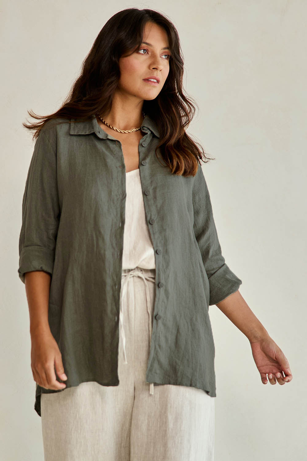 Model Tahneei wearing size 10 of the Linen Oversized Boyfriend Shirt - Olive in colour Olive, from an angle