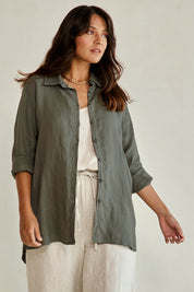 Model Tahneei wearing size 10 of the Linen Oversized Boyfriend Shirt - Olive in colour Olive, from an angle