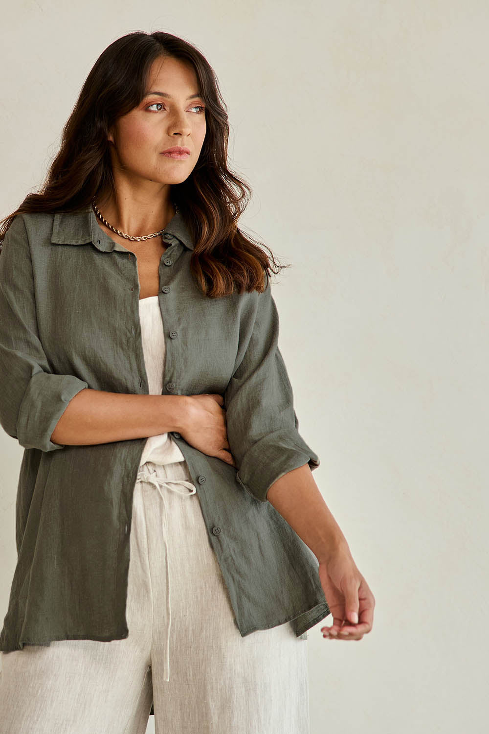 Model Tahneei wearing size 10 of the Linen Oversized Boyfriend Shirt - Olive in colour Olive, from an angle