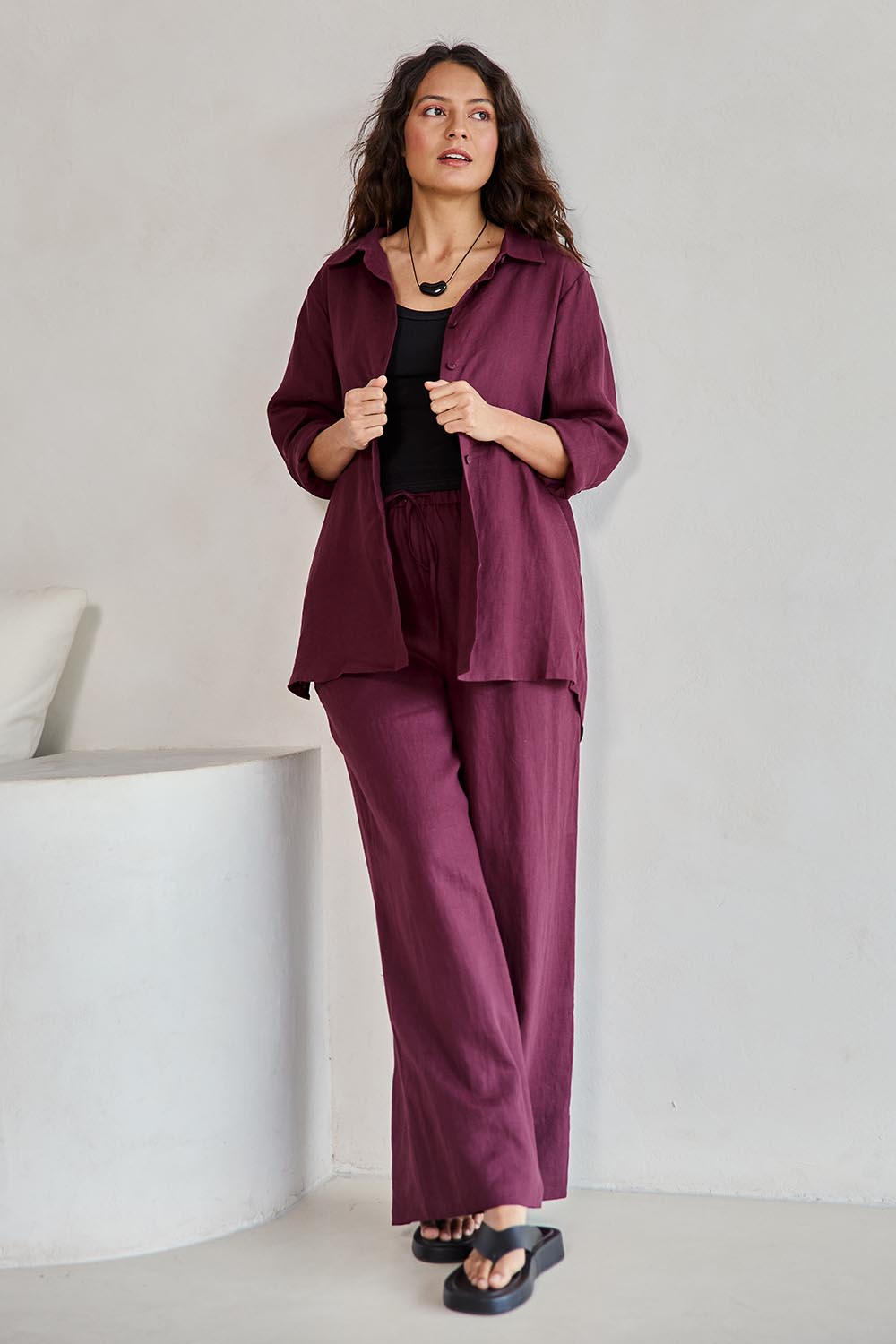 Model Tahneei wearing size 10 of the Linen Oversized Boyfriend Shirt – Plum in colour Plum, from the front