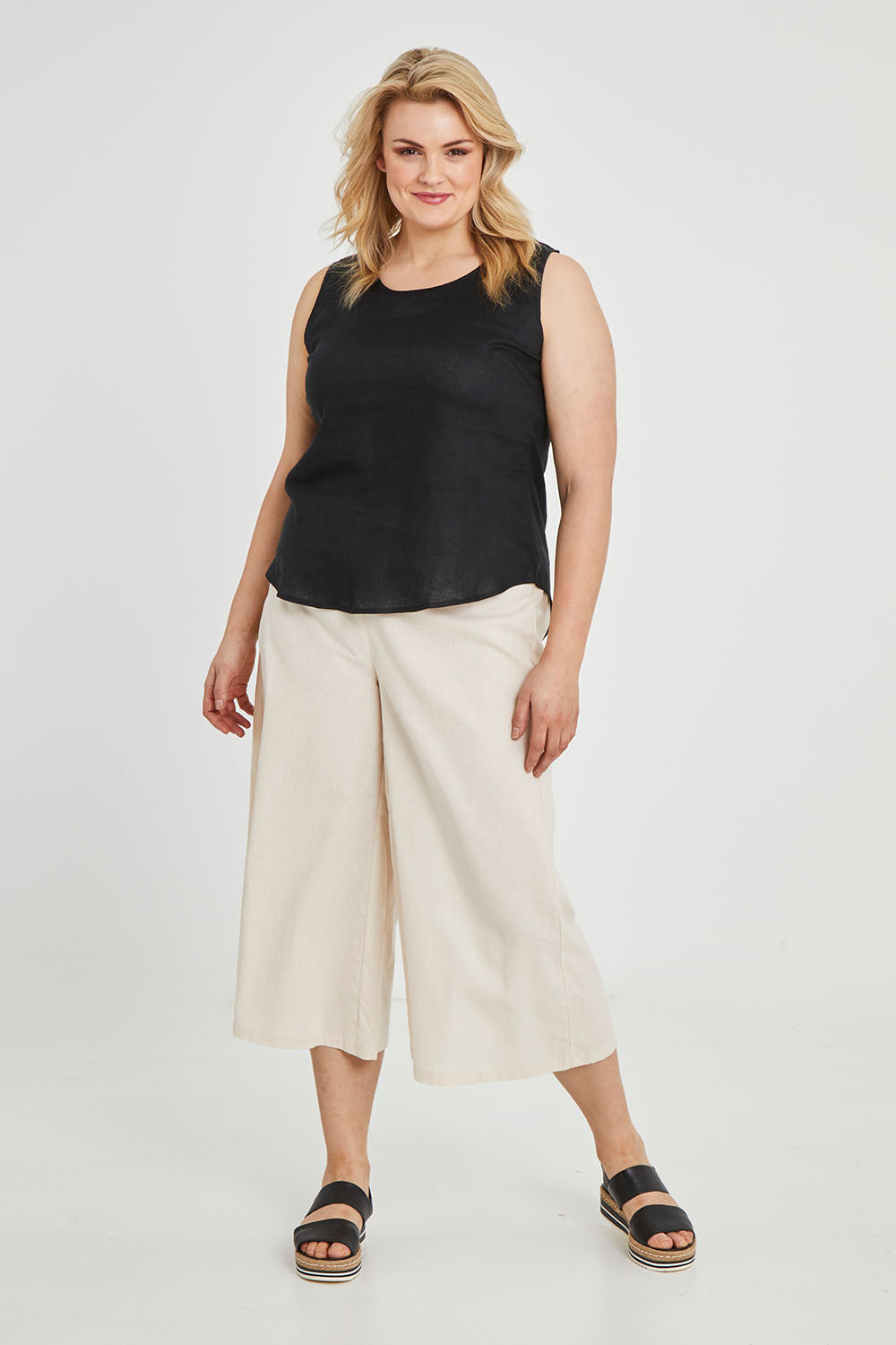 Model Keeara wearing size 16 of the Linen Tank in colour Black (Black), from the front, showing the whole outfit