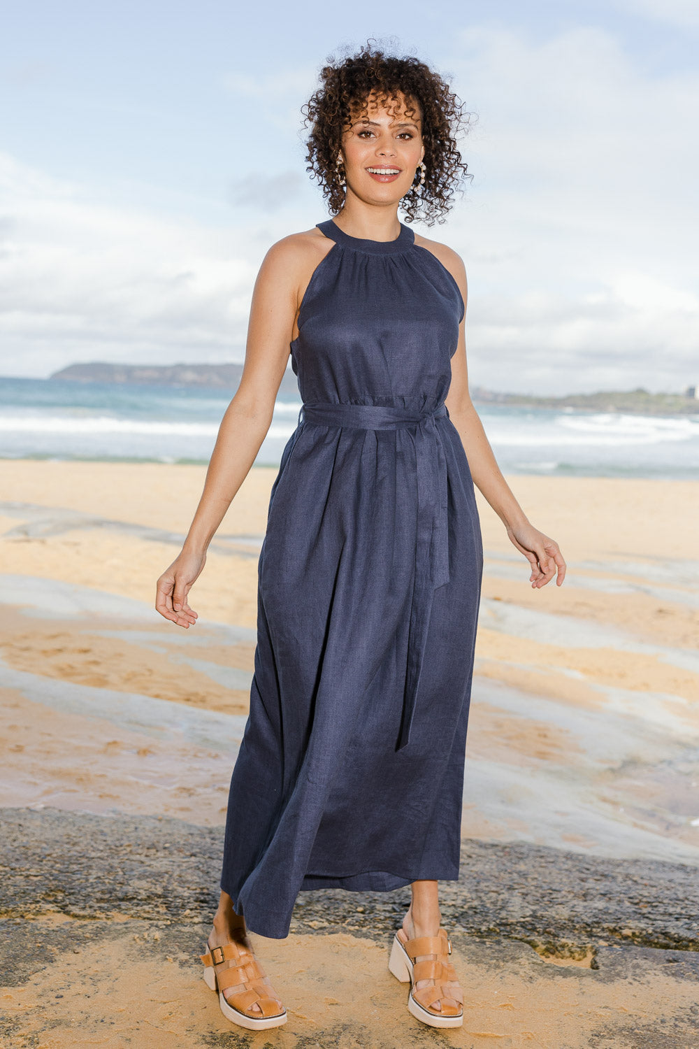 Model Lala wearing size 10 of the Linen Halter Neck Dress in colour Blue (Blue), from the front, showing the whole outfit
