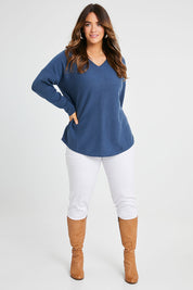 Model Laura wearing size S of the Wool Cashmere Sweater in colour Denim (Blue), from the front, showing the whole outfit