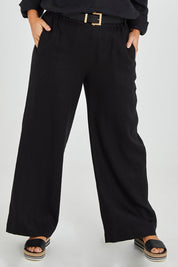 Model Monique wearing size 14 of the Linen Wide Leg Pant in colour Black (Black), from the front, cropped image
