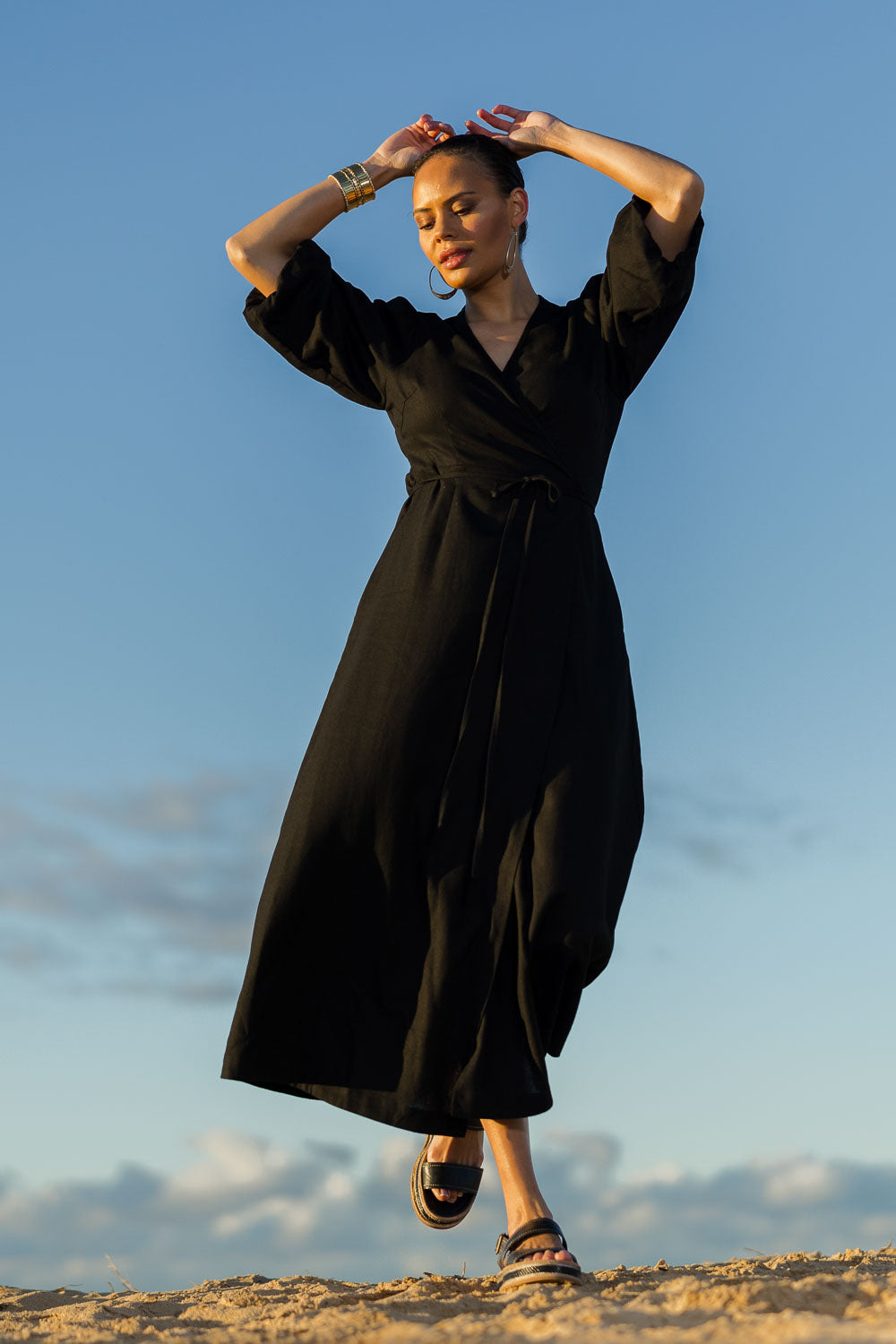 Model Lala wearing size 10 of the Linen Cotton Blend Wrap Dress in colour Black (Black), from the front, showing the whole outfit