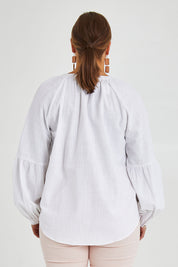 Model Monique wearing size 14 of the Relaxed Linen Blouse in colour White (White), from the back