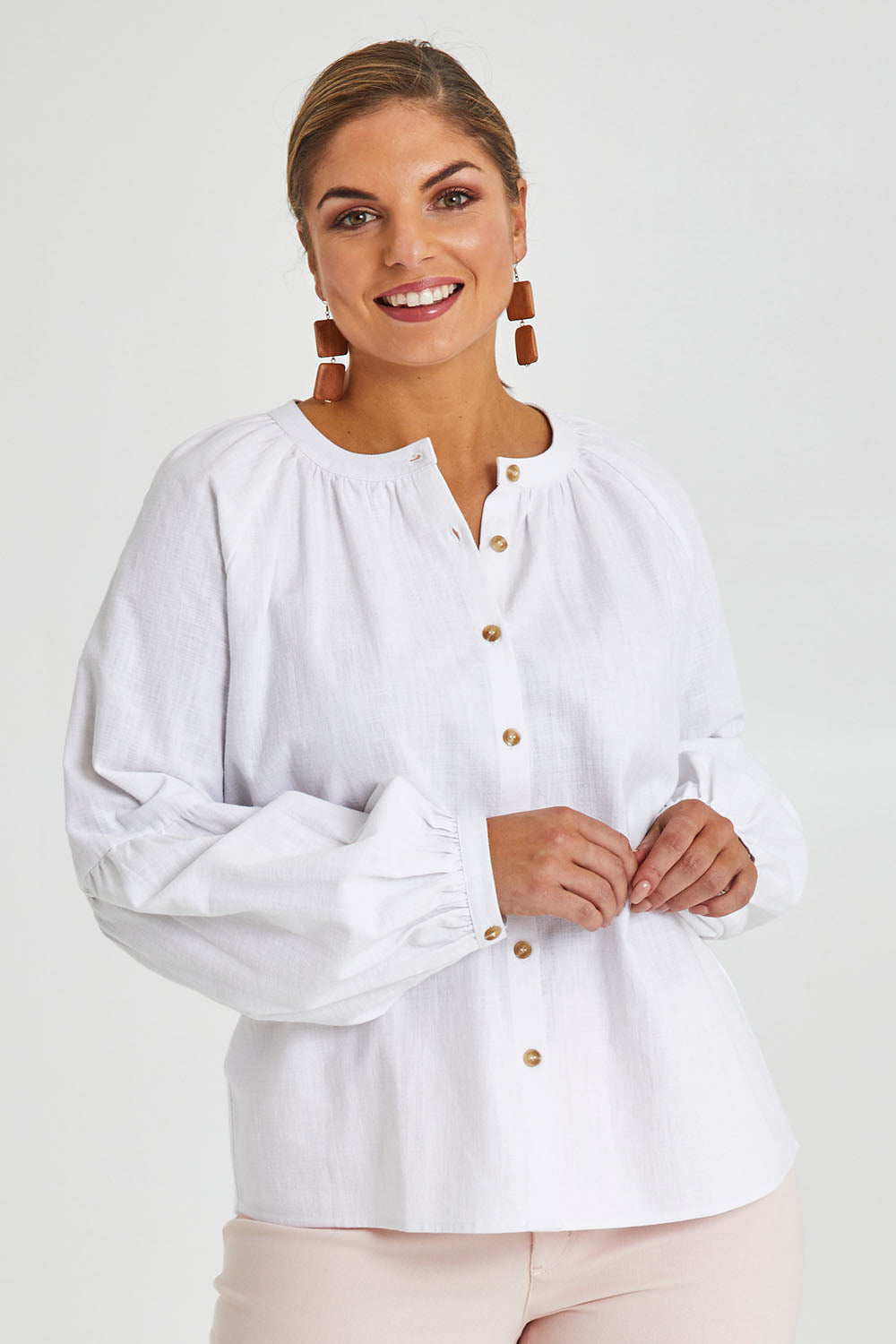 Model Monique wearing size 14 of the Relaxed Linen Blouse in colour White (White), from the front, cropped image