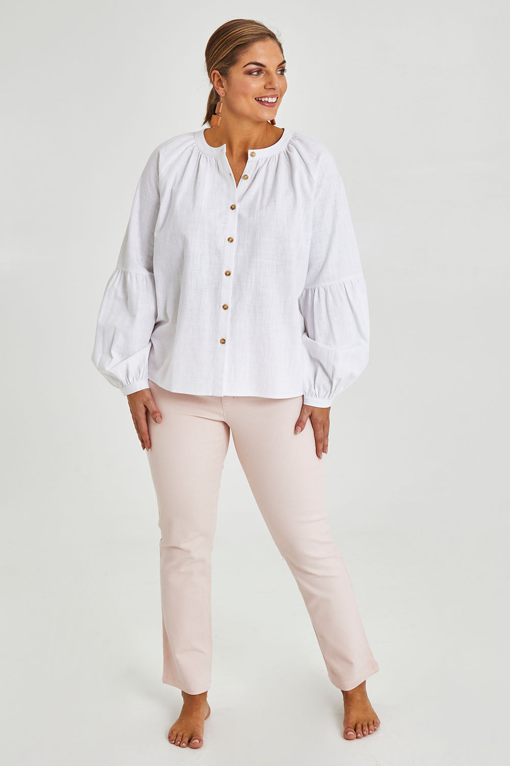 Model Monique wearing size 14 of the Relaxed Linen Blouse in colour White (White), from the front, showing the whole outfit