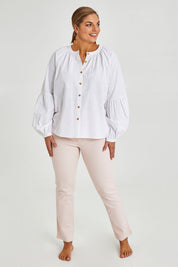 Model Monique wearing size 14 of the Relaxed Linen Blouse in colour White (White), from the front, showing the whole outfit
