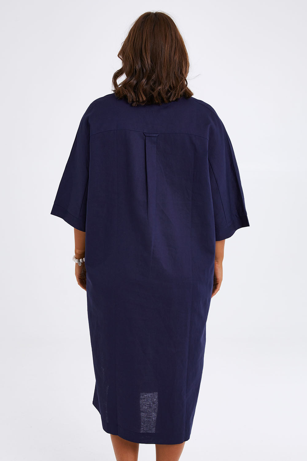 Model Monique wearing size 14 of the Linen Cotton Throw Dress in colour Navy (Blue), from the back