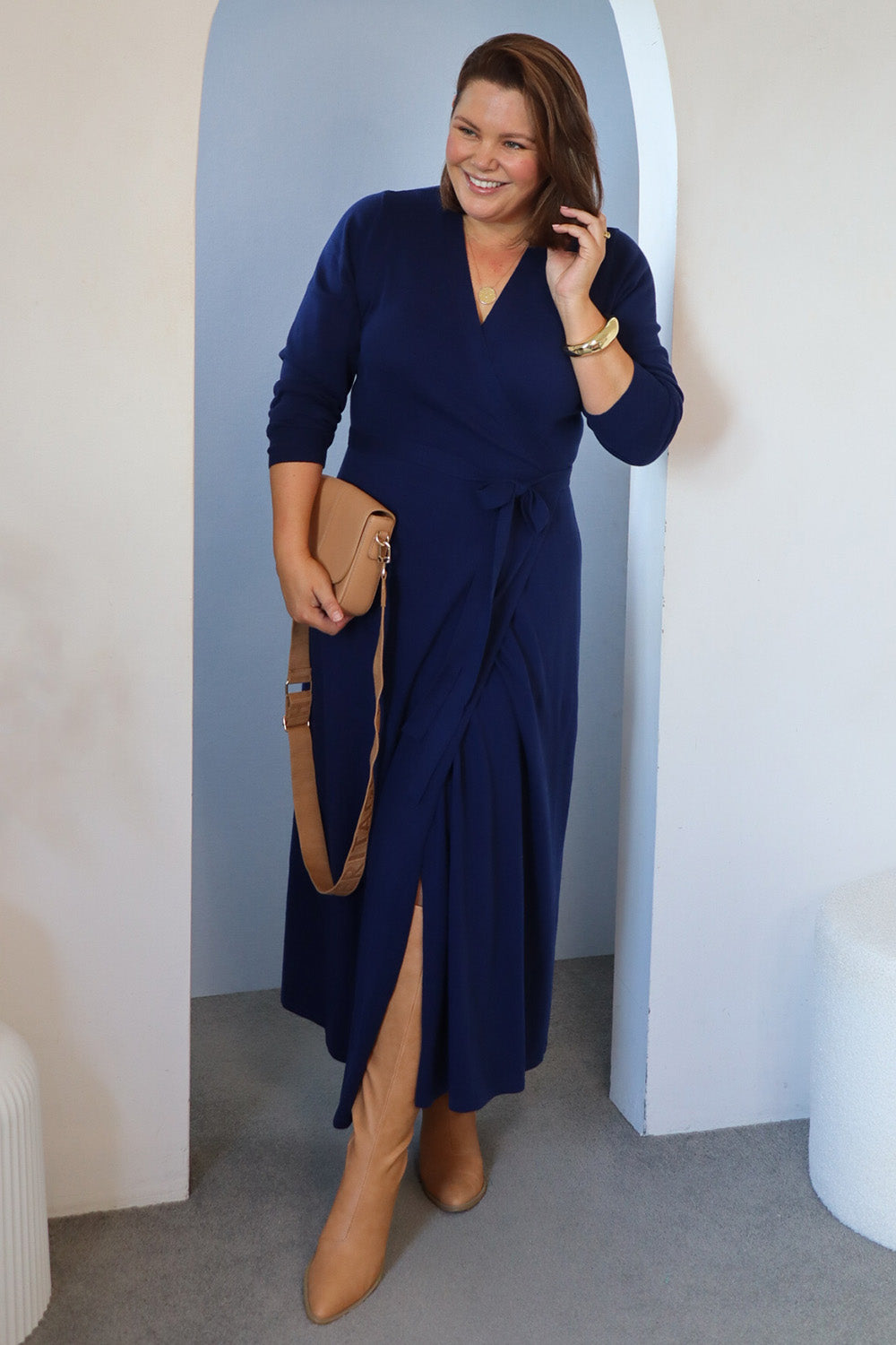 Model Stacey wearing size L of the Cotton Cashmere Wrap Dress in colour Navy (Blue), from the front, showing the whole outfit