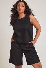 Model Terri-Leigh wearing size 14 of the Linen Cotton Long Short in colour Black (Black), from the front, cropped image