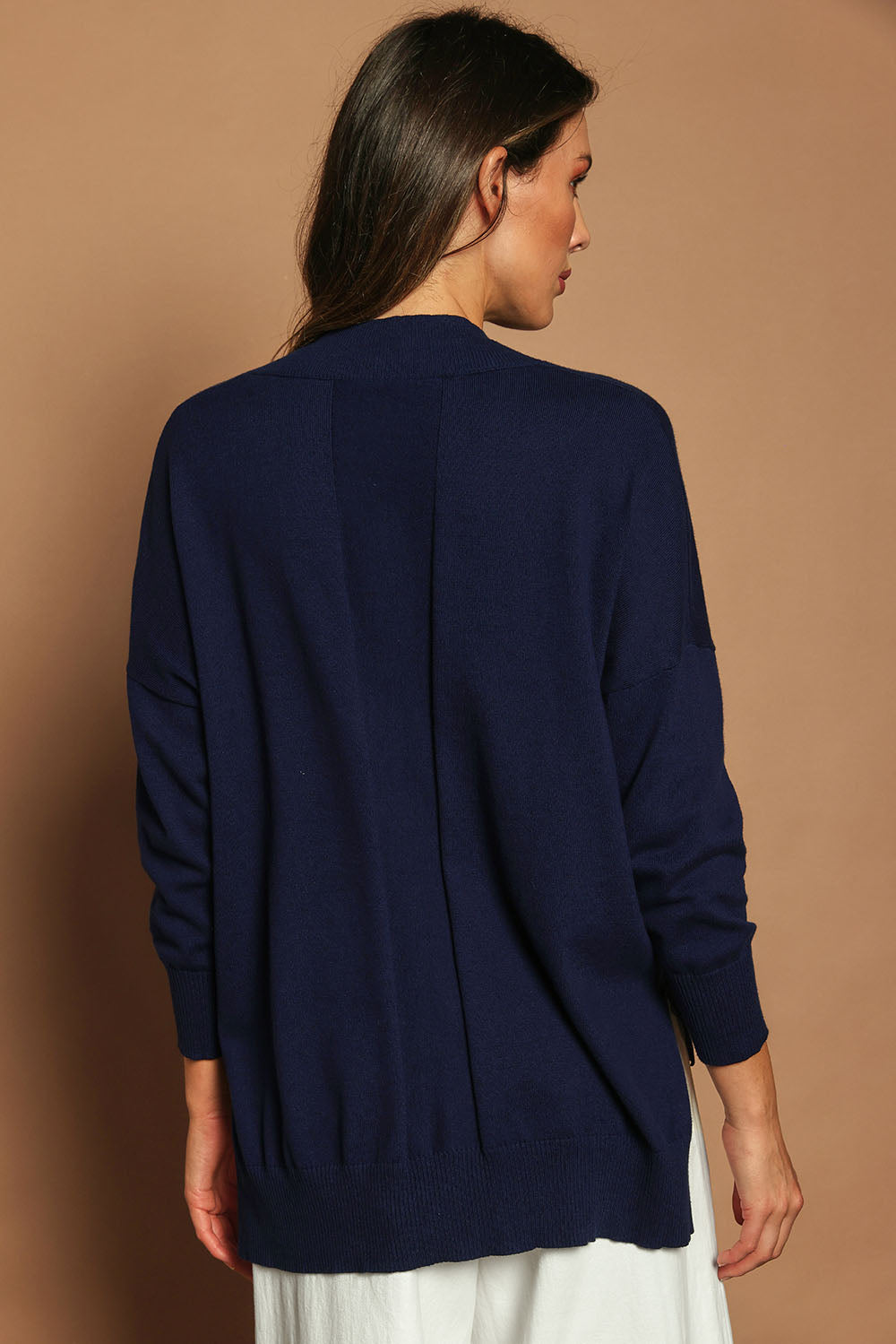 Model Madeline wearing size S of the Cotton Cashmere V Neck Sweater in colour Navy (Blue), from the back