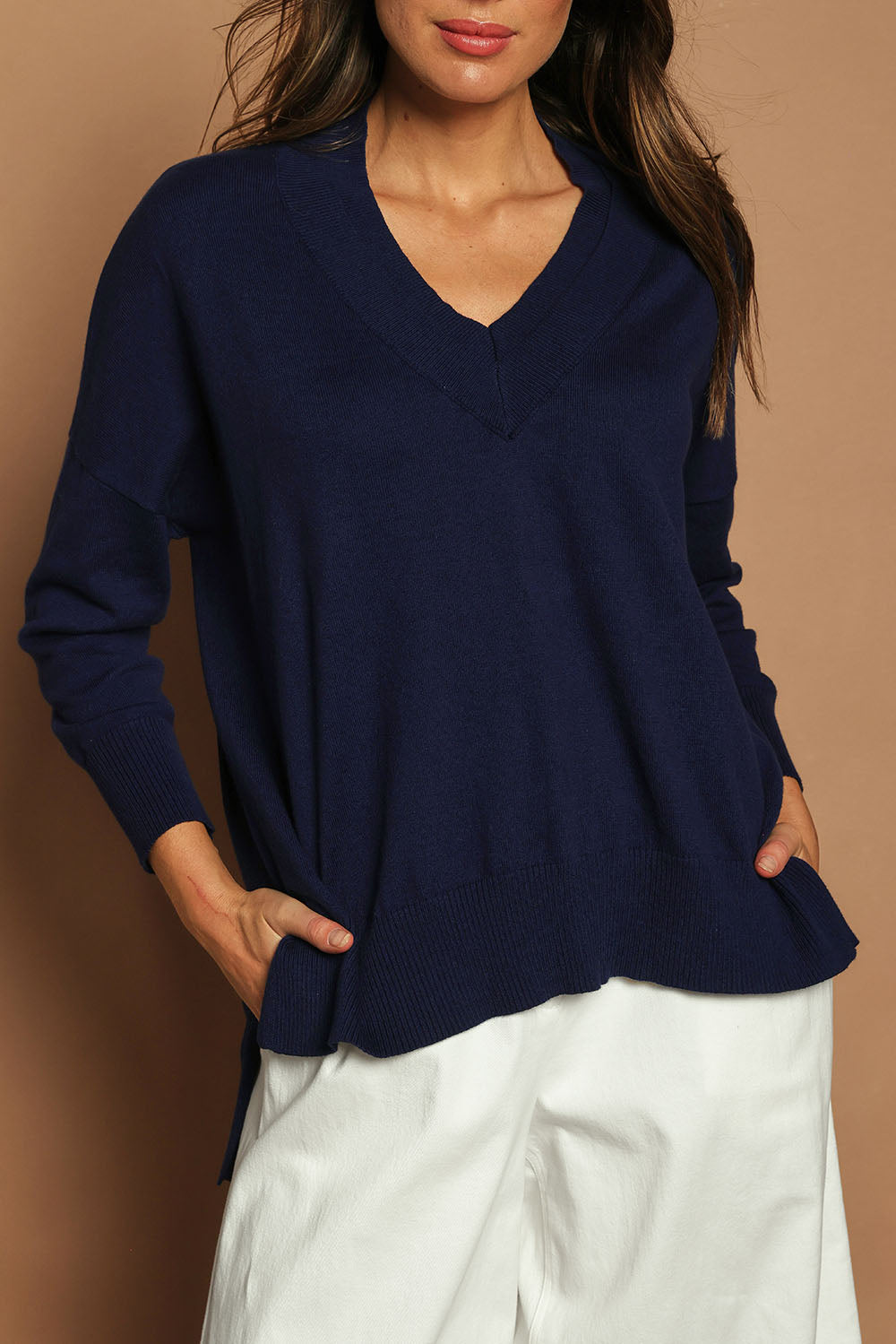 Model Madeline wearing size S of the Cotton Cashmere V Neck Sweater in colour Navy (Blue), from the front, cropped image