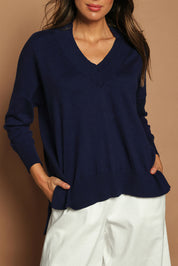 Model Madeline wearing size S of the Cotton Cashmere V Neck Sweater in colour Navy (Blue), from the front, cropped image