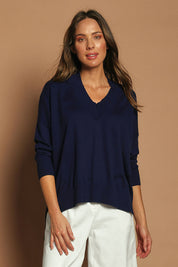 Model Madeline wearing size S of the Cotton Cashmere V Neck Sweater in colour Navy (Blue), from the front, showing the whole outfit