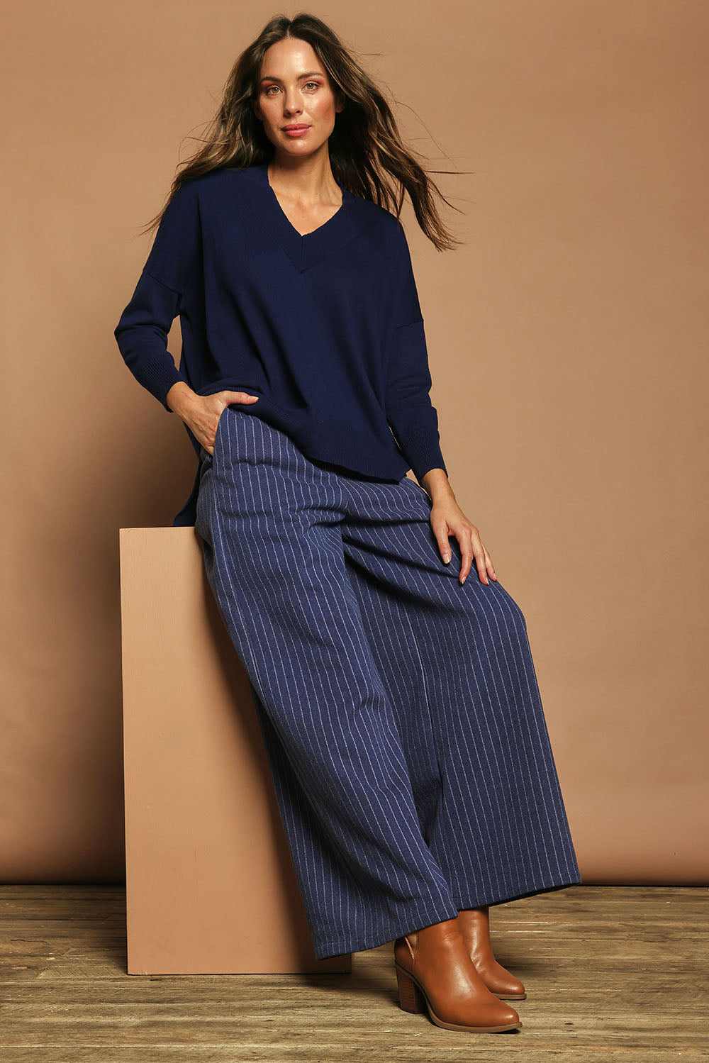Model Madeline wearing size S of the Cotton Cashmere V Neck Sweater in colour Navy (Blue), from the front, showing the whole outfit