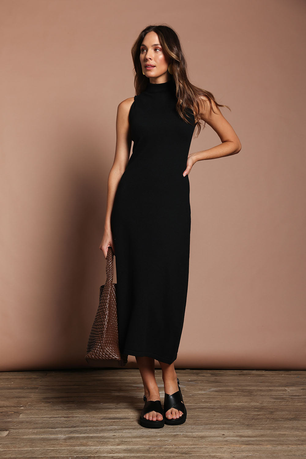 Model Madeline wearing size S of the Cotton Cashmere Sleeveless Layering Dress in colour Black (Black), from the front, showing the whole outfit