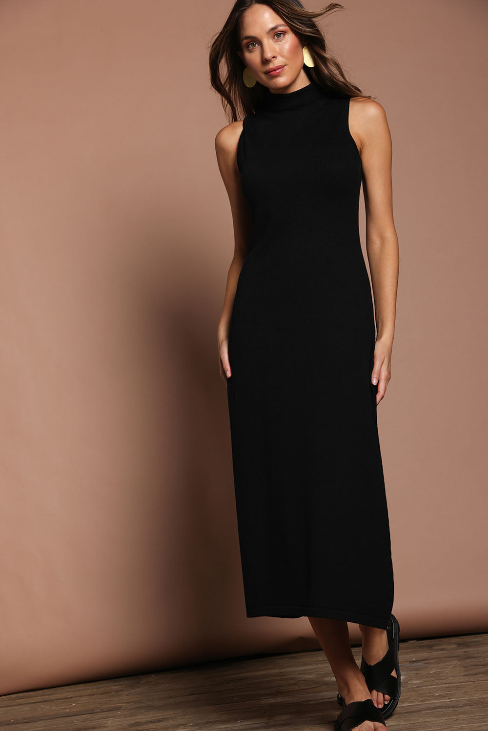 Model Madeline wearing size S of the Cotton Cashmere Sleeveless Layering Dress in colour Black (Black), from the front, showing the whole outfit