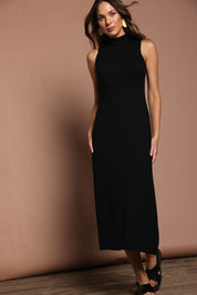 Model Madeline wearing size S of the Cotton Cashmere Sleeveless Layering Dress in colour Black (Black), from the front, showing the whole outfit