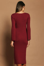 Model Madeline wearing size S of the Cotton Cashmere Boat Neck Dress in colour Berry (Red), from the back