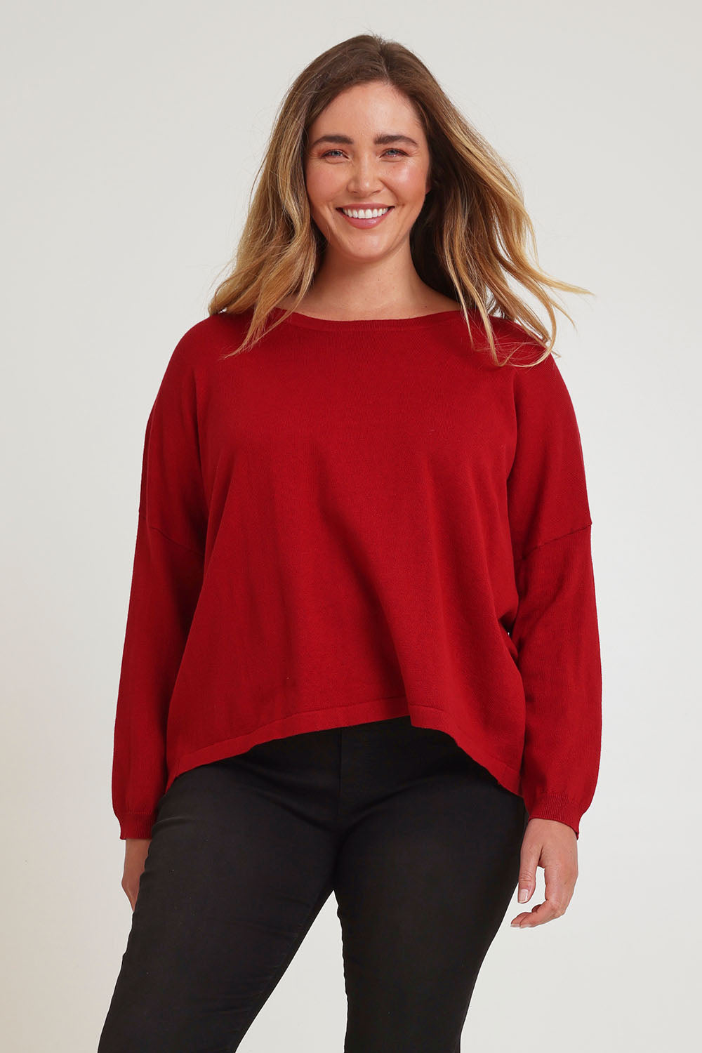 Model Chanel wearing size XL of the Cotton Cashmere Cross Back Sweater in colour Redrust (Red), from the front, cropped image
