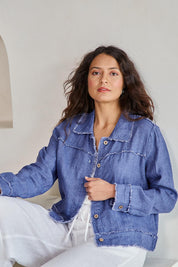 Model Tahneei wearing size 10 of the Linen Relaxed Jacket – Denim in colour Denim, in a cropped view