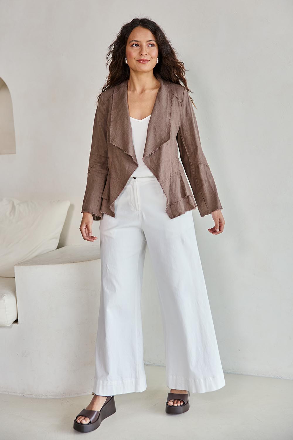 Model Tahneei wearing size 10 of the Linen Draped Jacket – Coffee in colour Coffee, from the front