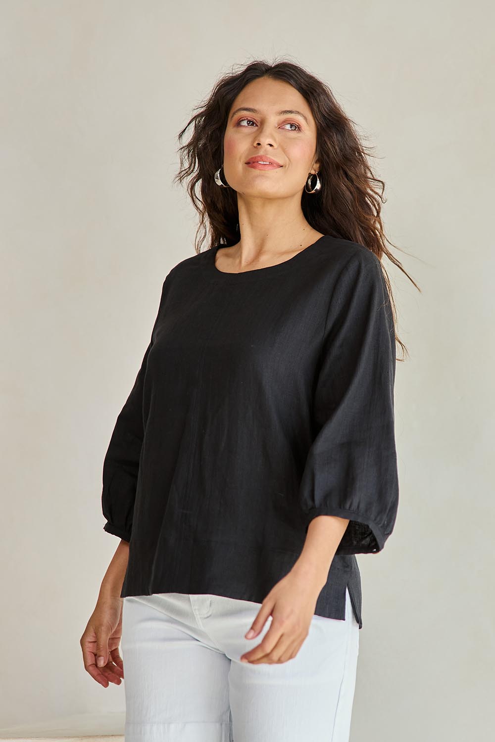 Model Tahneei wearing size 10 of the Linen 3/4 Sleeve Top – Black in colour Black, from an angle