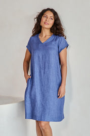 Model Tahneei wearing size 10 of the Linen V Neck Shift Dress – Denim in colour Denim, in a cropped view