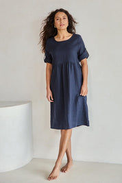 Model Tahneei wearing size 10 of the Linen Pocket Dress – Navy in colour Navy, from the front