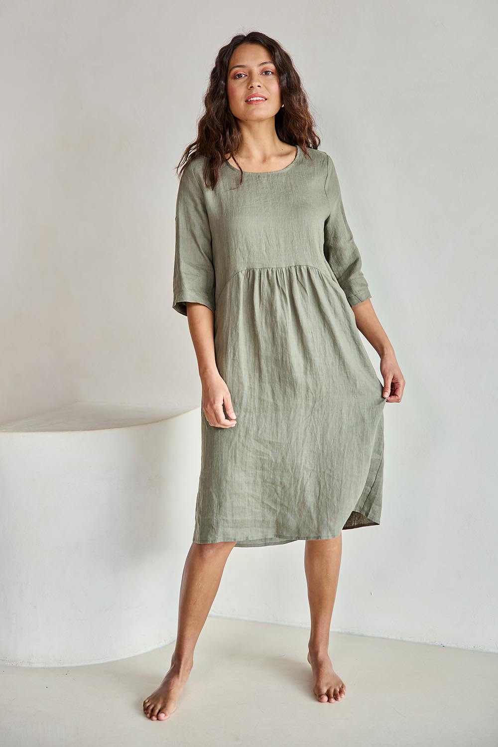 Model Tahneei wearing size 10 of the Linen Pocket Dress – Olive in colour Olive, from the front