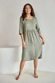 Model Tahneei wearing size 10 of the Linen Pocket Dress – Olive in colour Olive, from the front