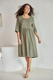Model Tahneei wearing size 10 of the Linen Pocket Dress – Olive in colour Olive, from the front